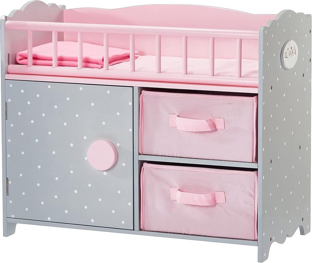Gray polka dot wooden doll crib with pink blanket, cabinet door and two fabric cubbies
